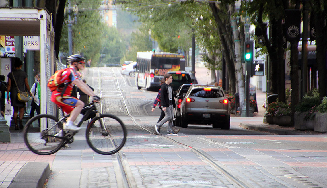 Bicyclist Crosses Road, Cobblestones, Bus, AARP, Public Policy Institute, Livable Communities, Transportation
